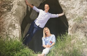 Zwei Personen posieren vor einer Felsenh&ouml;hle.